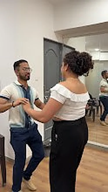 Dance lesson in front of the studio mirror