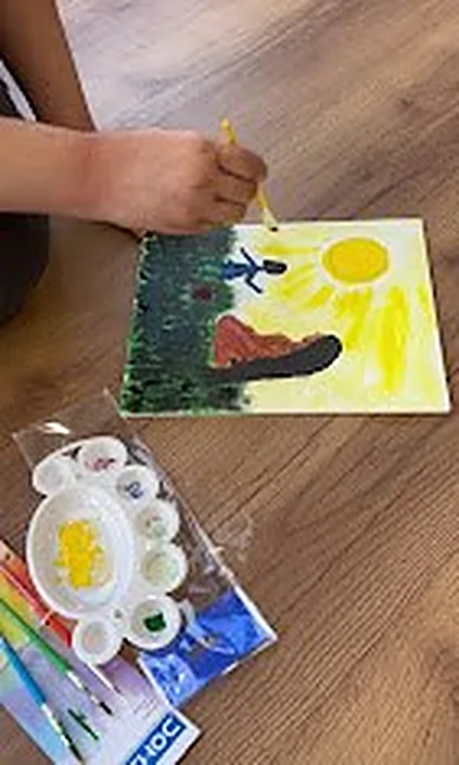 Children painting at a creative workshop