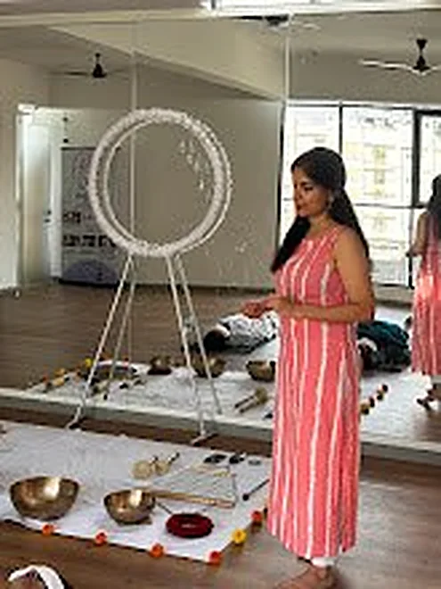 Sound healing facilitator with bowls in the studio