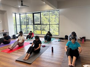 Yoga class on mats beside large windows at Safemind Studio, Baner, Pune